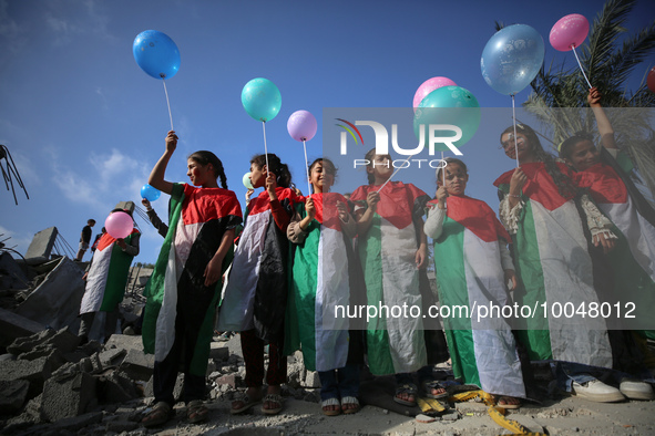 Palestinian children participate in an activity aimed to support the mental health of children affected by the recent Israel-Gaza fighting,...