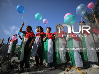 Palestinian children participate in an activity aimed to support the mental health of children affected by the recent Israel-Gaza fighting,...