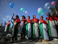 Palestinian children participate in an activity aimed to support the mental health of children affected by the recent Israel-Gaza fighting,...