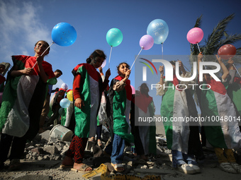 Palestinian children participate in an activity aimed to support the mental health of children affected by the recent Israel-Gaza fighting,...