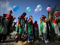 Palestinian children participate in an activity aimed to support the mental health of children affected by the recent Israel-Gaza fighting,...