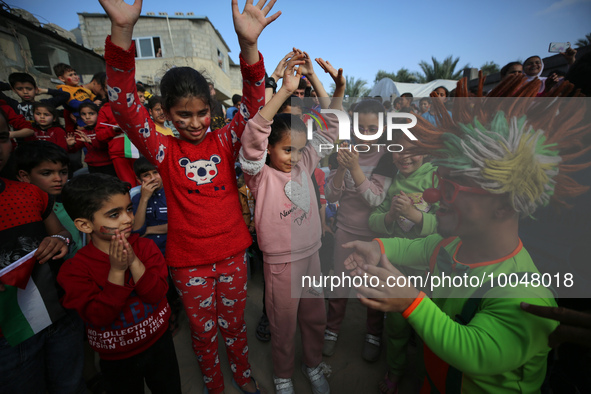 Palestinian children participate in an activity aimed to support the mental health of children affected by the recent Israel-Gaza fighting,...