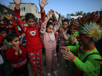 Palestinian children participate in an activity aimed to support the mental health of children affected by the recent Israel-Gaza fighting,...