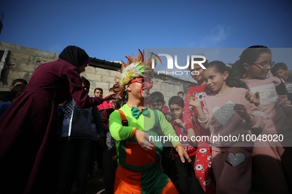 Palestinian children participate in an activity aimed to support the mental health of children affected by the recent Israel-Gaza fighting,...