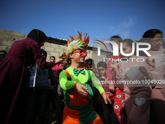 Palestinian children participate in an activity aimed to support the mental health of children affected by the recent Israel-Gaza fighting,...