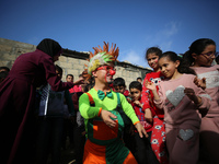 Palestinian children participate in an activity aimed to support the mental health of children affected by the recent Israel-Gaza fighting,...