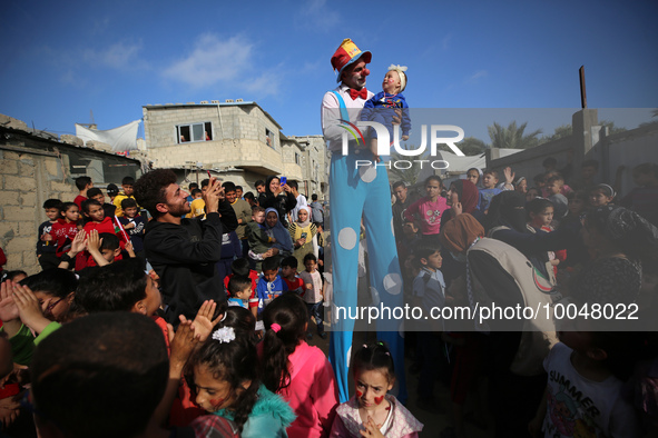 Palestinian children participate in an activity aimed to support the mental health of children affected by the recent Israel-Gaza fighting,...