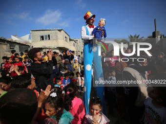 Palestinian children participate in an activity aimed to support the mental health of children affected by the recent Israel-Gaza fighting,...