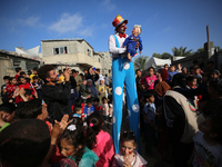 Palestinian children participate in an activity aimed to support the mental health of children affected by the recent Israel-Gaza fighting,...