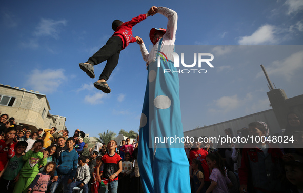 Palestinian children participate in an activity aimed to support the mental health of children affected by the recent Israel-Gaza fighting,...