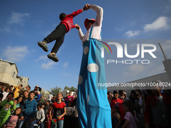 Palestinian children participate in an activity aimed to support the mental health of children affected by the recent Israel-Gaza fighting,...