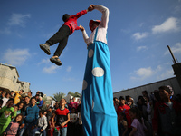 Palestinian children participate in an activity aimed to support the mental health of children affected by the recent Israel-Gaza fighting,...