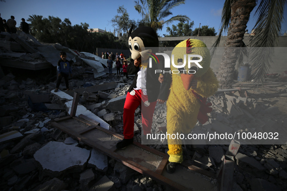 Palestinian children participate in an activity aimed to support the mental health of children affected by the recent Israel-Gaza fighting,...