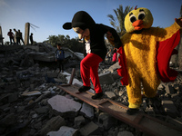 Palestinian children participate in an activity aimed to support the mental health of children affected by the recent Israel-Gaza fighting,...