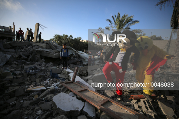 Palestinian children participate in an activity aimed to support the mental health of children affected by the recent Israel-Gaza fighting,...