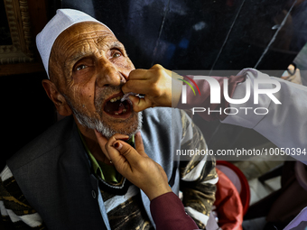 An elderly Muslim receive drops before leaving for Hajj during Hajj Vaccination program at SDH Sopore District Baramulla Jammu and Kashmir I...