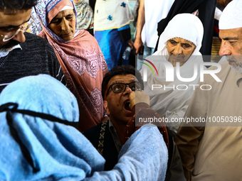 Kashmiri Muslims receive drops before leaving for Hajj during Hajj Vaccination program at SDH Sopore District Baramulla Jammu and Kashmir In...