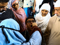 Kashmiri Muslims receive drops before leaving for Hajj during Hajj Vaccination program at SDH Sopore District Baramulla Jammu and Kashmir In...