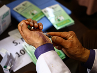 A health worker fills a Syringe with Vaccine during a Vaccination drive ahead of Hajj pilgrimage at SDH Sopore District Baramulla Jammu and...