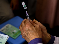 A health worker fills a Syringe with Vaccine during a Vaccination drive ahead of Hajj pilgrimage at SDH Sopore District Baramulla Jammu and...