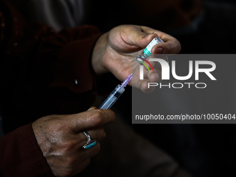 A health worker fills a Syringe with Vaccine during a Vaccination drive ahead of Hajj pilgrimage at SDH Sopore District Baramulla Jammu and...