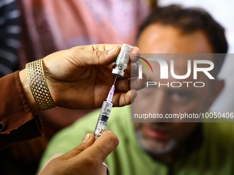 A health worker fills a Syringe with Vaccine during a Vaccination drive ahead of Hajj pilgrimage at SDH Sopore District Baramulla Jammu and...