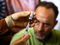 A health worker fills a Syringe with Vaccine during a Vaccination drive ahead of Hajj pilgrimage at SDH Sopore District Baramulla Jammu and...