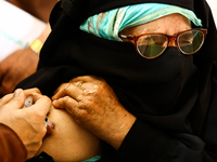 A woman recieves a dose of Vaccine during Hajj pilgrimage vaccination program in Sopore District Baramulla Jammu and Kashmir India on 16 May...