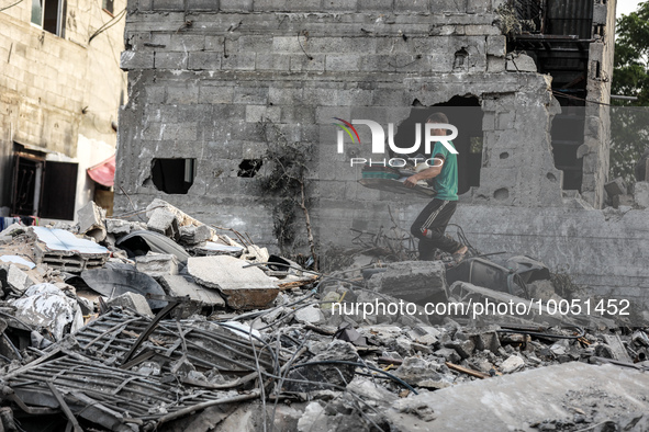 A Palestinian walks over the rubble of a building destroyed by Israeli air strikes on May 13, following a ceasefire ending five days of dead...