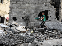 A Palestinian walks over the rubble of a building destroyed by Israeli air strikes on May 13, following a ceasefire ending five days of dead...