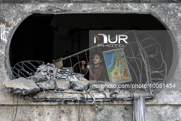 A Palestinian girl looks at the rubble of a building, following an Israeli air strike, following a ceasefire ending five days of deadly figh...