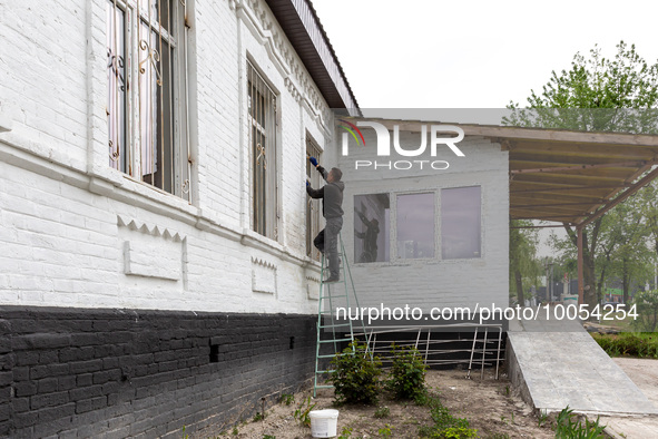 A volunteer from Gurtum foundation works in the school which his NGO reconstructs after the building was damaged by at least 3 bombs in Host...