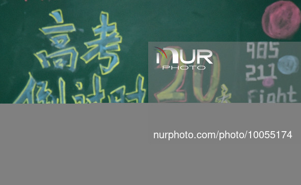 A student who is about to take the National College entrance exam stretches during a self-study class at Fengfeng No 1 Middle School in Hand...