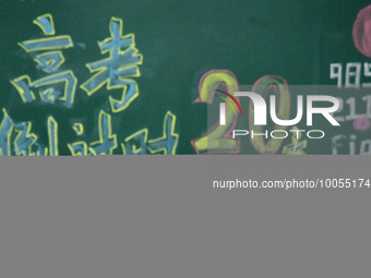 A student who is about to take the National College entrance exam stretches during a self-study class at Fengfeng No 1 Middle School in Hand...