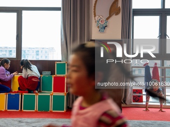  Two students of Peking Opera club do their homework and a child practices kung fu in Hai 'an, East China's Jiangsu province, May 20, 2023....