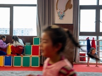  Two students of Peking Opera club do their homework and a child practices kung fu in Hai 'an, East China's Jiangsu province, May 20, 2023....