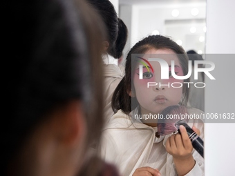  A young performer touches up her makeup at a primary school Peking Opera club in Hai 'an, East China's Jiangsu province, May 20, 2023. (