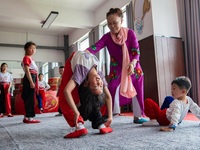  A teacher of a primary school Peking Opera club instructs students to practice basic skills in Hai 'an, East China's Jiangsu province, May...