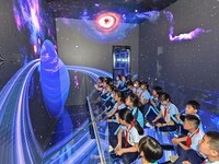 QINGZHOU, CHINA - MAY 23, 2023 - Primary school students experience the origin of the Earth at the Artificial Intelligence Learning Experien...