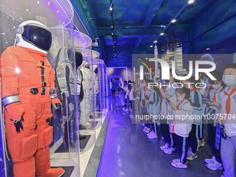 QINGZHOU, CHINA - MAY 23, 2023 - Primary school students watch and take photos of a space suit model at the Artificial Intelligence Learning...