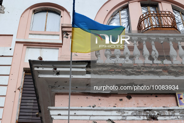 OKHTYRKA, UKRAINE - MAY 24, 2023 - A Ukrainian flag flies outside a building in the city centre damaged by Russian shelling, Okhtyrka, Sumy...