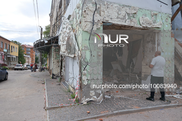 OKHTYRKA, UKRAINE - MAY 24, 2023 - A man looks inside a building damaged by Russian shelling, Okhtyrka, Sumy Region, northeastern Ukraine.NO...