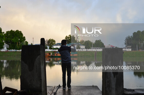 People click pictures of Rainbow after heavy rainfall in Srinagar, Indian Administered Kashmir on 25 May 2023. Rainfall will continue in the...