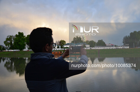 People click pictures of Rainbow after heavy rainfall in Srinagar, Indian Administered Kashmir on 25 May 2023. Rainfall will continue in the...