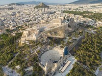 Aerial panoramic view from a drone of the Acropolis of Athens, a rocky outcrop above the city of Athens with many remains of several ancient...