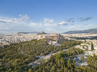 Aerial panoramic view from a drone of the Acropolis of Athens, a rocky outcrop above the city of Athens with many remains of several ancient...