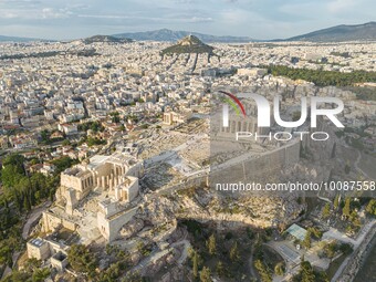 Aerial panoramic view from a drone of the Acropolis of Athens, a rocky outcrop above the city of Athens with many remains of several ancient...