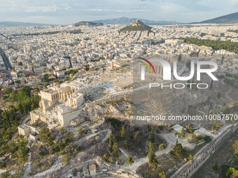 Aerial panoramic view from a drone of the Acropolis of Athens, a rocky outcrop above the city of Athens with many remains of several ancient...