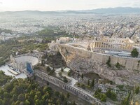 Aerial panoramic view from a drone of the Acropolis of Athens, a rocky outcrop above the city of Athens with many remains of several ancient...