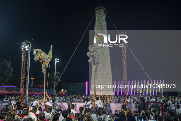 Lion dancers in front of the bun tower on May 26, 2023 in Hong Kong, China. Cheung Chau Bun Festival or Cheung Chau Da Jiu Festival is a tra...